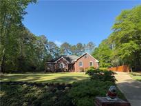 Beautiful brick home with mature trees and professional landscaping at 501 Wedgepark Dr, Mcdonough, GA 30252