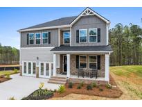 Charming two-story home with brick accents, covered porch, and well-maintained landscaping at 734 Great Oak Pl, Villa Rica, GA 30180