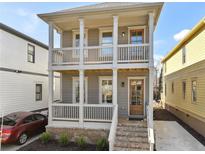 Charming two-story home featuring a welcoming front porch with white railings and a brick foundation at 106 Hogue St, Atlanta, GA 30312