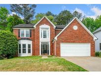 Charming two-story red brick home with a well-manicured lawn, attached two-car garage, and mature trees at 3969 Bear Ridge Nw Pl, Kennesaw, GA 30144