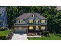 Beautiful two-story home with a stone accent, manicured lawn, and an inviting front porch at 6765 Creek View Ln, Cumming, GA 30041