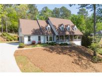 Charming home featuring a welcoming front porch and a well-manicured front yard at 7700 Dunvegan Close, Atlanta, GA 30350