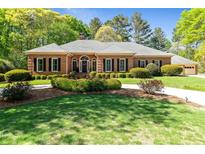 Charming single-story brick home featuring a landscaped yard and a welcoming front entrance at 8518 Shoreview Ct, Jonesboro, GA 30236