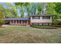 Traditional two-story home with a brick facade, neutral siding, well-maintained lawn, and a covered carport at 2921 Country Squire Ln, Decatur, GA 30033