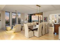 Bright dining and living room area with city views, natural light, modern decor and beautiful hardwood flooring at 3107 Peachtree Ne Rd # 1403, Atlanta, GA 30305