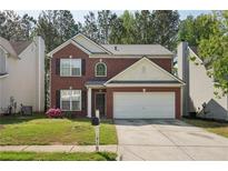 Charming two-story brick home with a well-manicured front yard and a two-car garage at 415 Clairidge Sw Ln, Lawrenceville, GA 30046