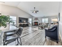 Spacious living room features wood floors, vaulted ceilings and a cozy fireplace at 305 Nobleman Way, Canton, GA 30114