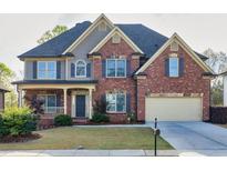 Charming two-story brick home featuring a manicured lawn and attached two car garage at 3634 Lost Oak Dr, Buford, GA 30519