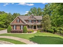 Beautiful two-story brick home with manicured lawn and charming front porch at 150 Fitzroy Ln, Acworth, GA 30101