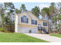 Charming two-story home with a well-maintained lawn, two-car garage and inviting front stairs at 7806 Poppy Seed Pl, Winston, GA 30187