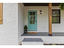 Charming home entrance featuring a light blue front door and brick facade with the house number clearly displayed at 225 Valley Dr, Roswell, GA 30075