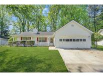 Charming single-story home with a well-manicured lawn and attached two-car garage at 2139 Briar Glen Sw Ln, Atlanta, GA 30331