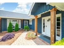 Charming home exterior featuring brick facade, lush landscaping, and a welcoming entrance at 2155 Old Dallas Rd, Marietta, GA 30064