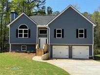 Charming two-story home with a two-car garage and manicured front lawn at 202 Gamel Rd, Dallas, GA 30157