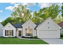 Charming home with white stone facade, black roof, manicured lawn, and bright, sunny skies at 290 Magnolia Walk Ln, Atlanta, GA 30349