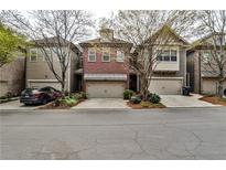 Charming brick townhouse with an attached garage and well-maintained landscaping at 2250 W Village Junction Se Way, Smyrna, GA 30080