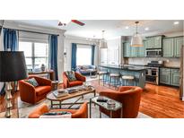 Open-concept living area with colorful decor and modern kitchen featuring a breakfast bar and updated appliances at 2250 W Village Junction Se Way, Smyrna, GA 30080