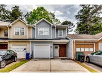 Charming townhome featuring a one-car garage, neutral colors and brick accents at 3620 Spring Trce, Decatur, GA 30034