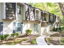 Charming townhouse exterior with a walkway, balconies, and lush landscaping at 725 Dalrymple Rd # 3G, Atlanta, GA 30328
