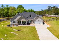 Charming single Gathering home boasts a long driveway and well-manicured lawn at 7001 Palomino Trl, Winston, GA 30187