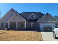 Charming single story home features a manicured lawn and attached two car garage at 7001 Palomino Trl, Winston, GA 30187