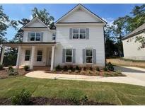 Charming two-story home featuring white siding, gray shutters and a beautifully landscaped front yard at 4517 Ajo Walk, Atlanta, GA 30331