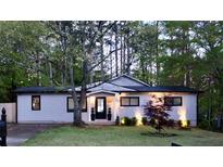 Charming single-story home with beautifully landscaped front yard and well-lit entrance at 1416 Sycamore Nw Dr, Kennesaw, GA 30152
