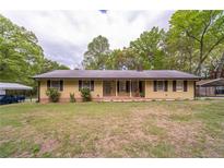 Charming single-story home featuring a cozy front porch and well-manicured lawn at 284 Zion Wood Rd, Loganville, GA 30052