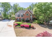 Beautiful two-story brick home with lush landscaping and a well-manicured lawn at 860 Cramac Dr, Lawrenceville, GA 30046