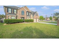 Lovely brick home with a manicured lawn and a two-car garage, perfect for suburban living at 4180 West Stubbs Rd, College Park, GA 30349