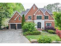 Beautiful brick home featuring an attached two-car garage and a meticulously landscaped front yard at 4730 W Forest Peak, Marietta, GA 30066