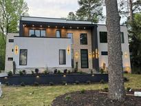 Stunning modern home featuring a tiered front yard and exterior lighting at 820 Moores Mill Nw Rd, Atlanta, GA 30327