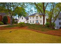 Charming white brick home with a well-manicured lawn and mature trees at 914 Denmeade Sw Walk, Marietta, GA 30064