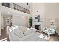 Bright living room features a fireplace, soaring ceilings, and a view of the second story balcony at 2890 Canter Meadow Dr, Cumming, GA 30040