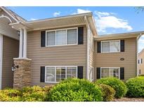Tan two-story condo with black shutters and well-manicured landscaping at 1468 Briarwood Ne Rd # 602, Atlanta, GA 30319
