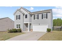 Charming two-story home with gray siding, black shutters, and a well-manicured front yard at 4655 Bluffton Ct, Cumming, GA 30028