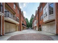 Charming brick townhomes with private garages and a brick courtyard create a desirable neighborhood setting at 774 Piedmont Ne Ave # 11B, Atlanta, GA 30308