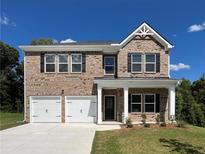 Charming two-story brick home with a two-car garage and manicured front lawn at 663 Egrets Landing Lot #55, Covington, GA 30014