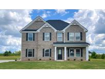 Charming two-story brick home with dark shutters and a well-manicured lawn at 669 Egrets Lot 56 Lndg, Covington, GA 30014