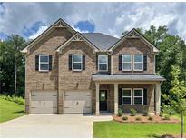 Attractive two-story brick home featuring a two-car garage and manicured front yard at 669 Egrets Lot 56 Lndg, Covington, GA 30014