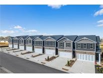 New townhomes boast stylish exteriors, attached garages, and manicured landscaping for a modern, appealing aesthetic at 11569 Kimberly Way # 26, Hampton, GA 30228