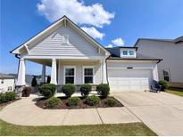 Charming home with a two-car garage, well-manicured lawn, and inviting front porch at 5515 Allegre Pl, Cumming, GA 30028