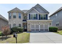 Charming two-story brick home with a well-manicured lawn and attached two-car garage at 5976 Princeton Run Trl, Tucker, GA 30084