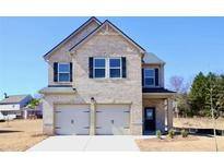 Charming two-story brick home with a two-car garage and a well-manicured front yard at 685 Egrets Lot 58 Lndg, Covington, GA 30014
