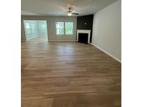 Spacious living room features hardwood floors, natural light, and a cozy fireplace at 2108 Amaryllis Dr, Grayson, GA 30017