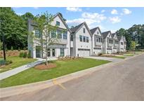 Charming exterior view of townhomes with manicured lawns and inviting curb appeal at 114 Briargate Dr, Johns Creek, GA 30097