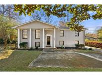 Charming gray brick home with large front windows and landscaped yard, creating an inviting curb appeal at 1393 Cerro Vista Dr, Atlanta, GA 30316