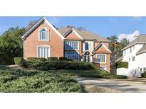 Elegant brick home featuring manicured landscaping and a charming two-story design at 120 Milano Sw Dr, South Fulton, GA 30331