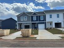 New townhomes with garages, driveways, and landscaping under construction at 9466 Cedar Grove Ct # 326, Jonesboro, GA 30238