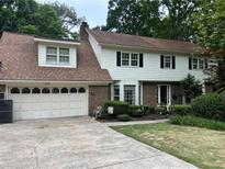Charming two-story home with white siding, brick accents, and a well-maintained front yard and two-car attached garage at 3798 Lee Ridge Sw Way, Lilburn, GA 30047